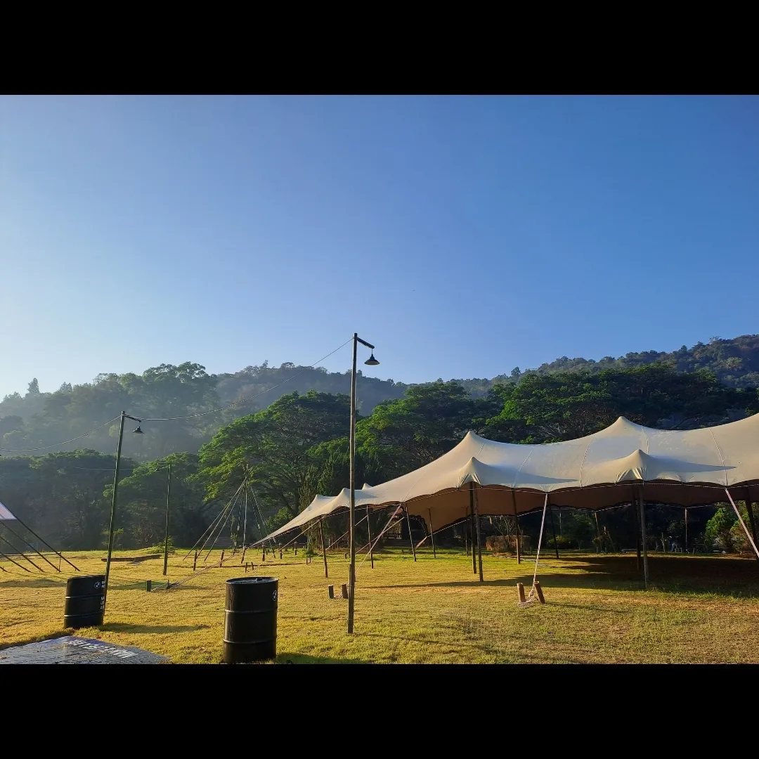Festival crowd gathered under a stretch tent in Thailand